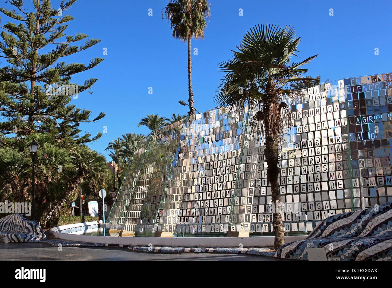 Seen from the rear - the many silver reflective plates with cut-out letters forming words adorn the cascade fountain in the centre of Torrevieja, 2020 Stock Photo