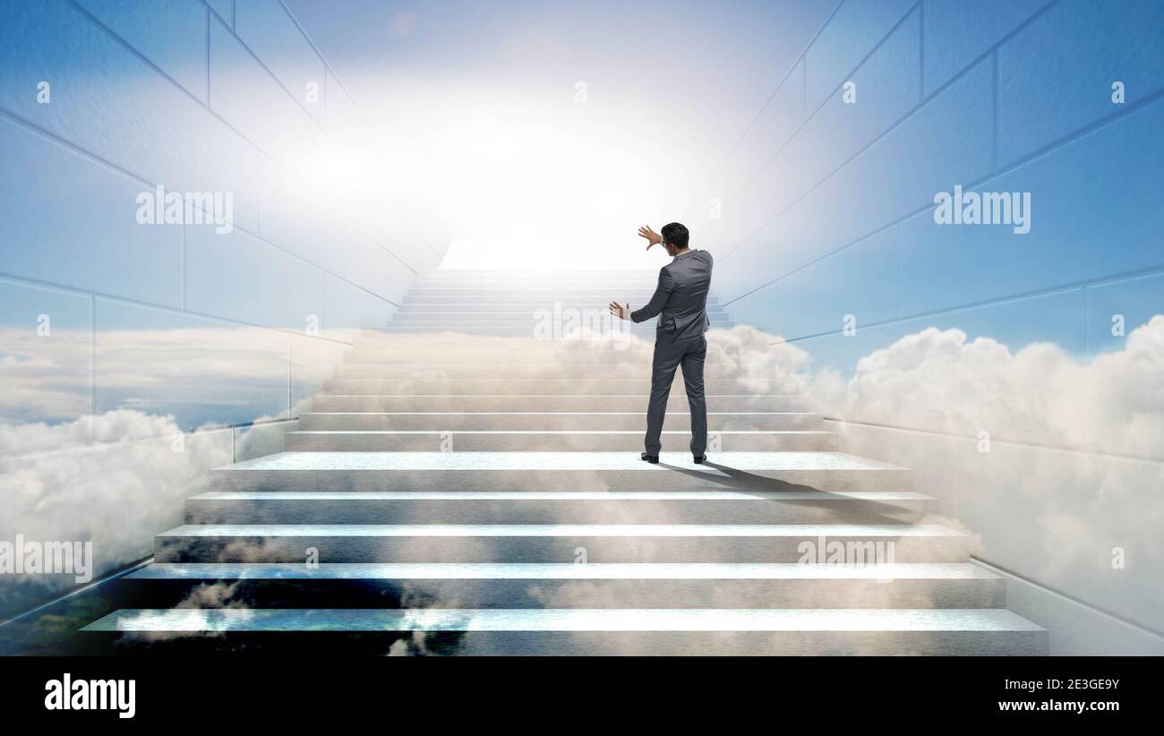 Businessman climbing up challenging career ladder in business concept ...