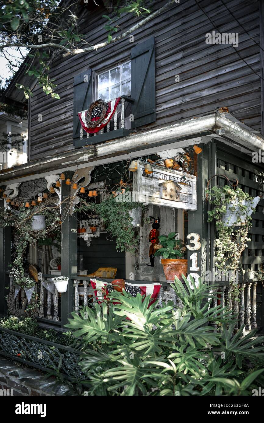 An artistic garden with birds' nest at the eclectic Dove Cote Garden shop, with sign and front porch in historic Fernandina Beach, Amelia Island, FL Stock Photo