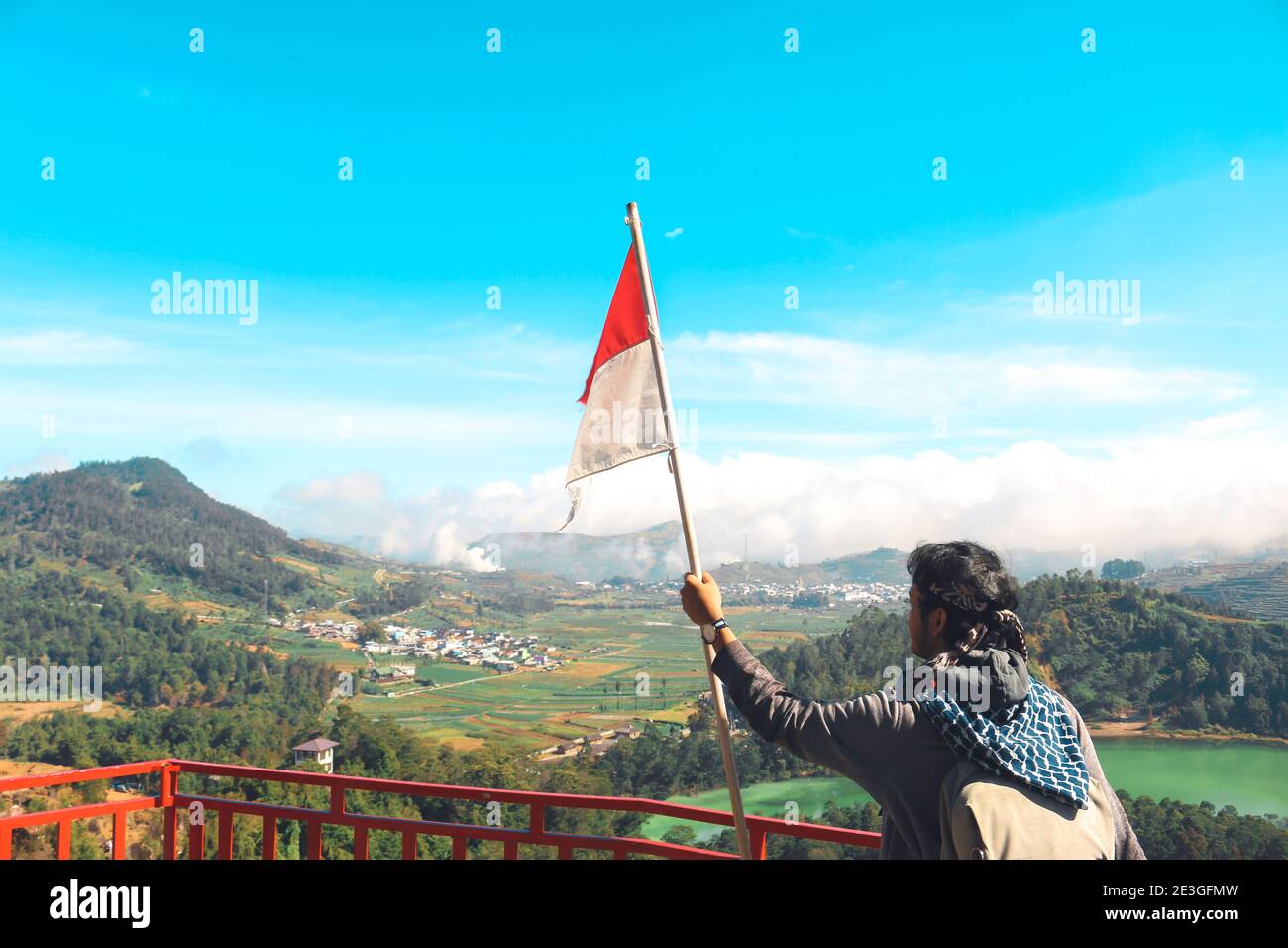 Man standing on top of a mountain holding a flag hi-res stock ...