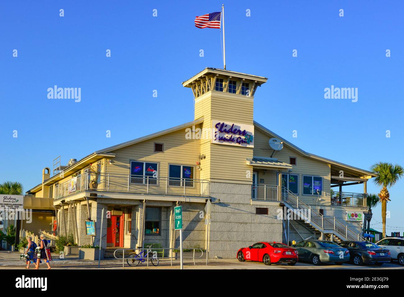 A coastal style commercial building housing the 'Sliders Seaside Grill' restaurant nearing sunset at Fernandina Beach on Amelia Island, FL Stock Photo