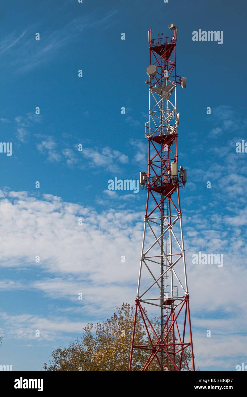 4G 5G cellular repeaters against a blue sky. Mobile phone Telecommunication Radio antenna Tower Stock Photo