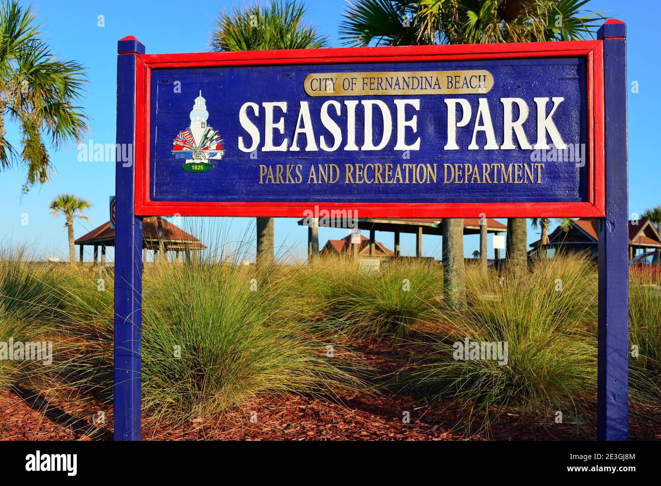 A blue and red wooden sign posted by the Park and Rec Department of City of Fernandina Beach Seaside Park, on Ameila Island, FL Stock Photo