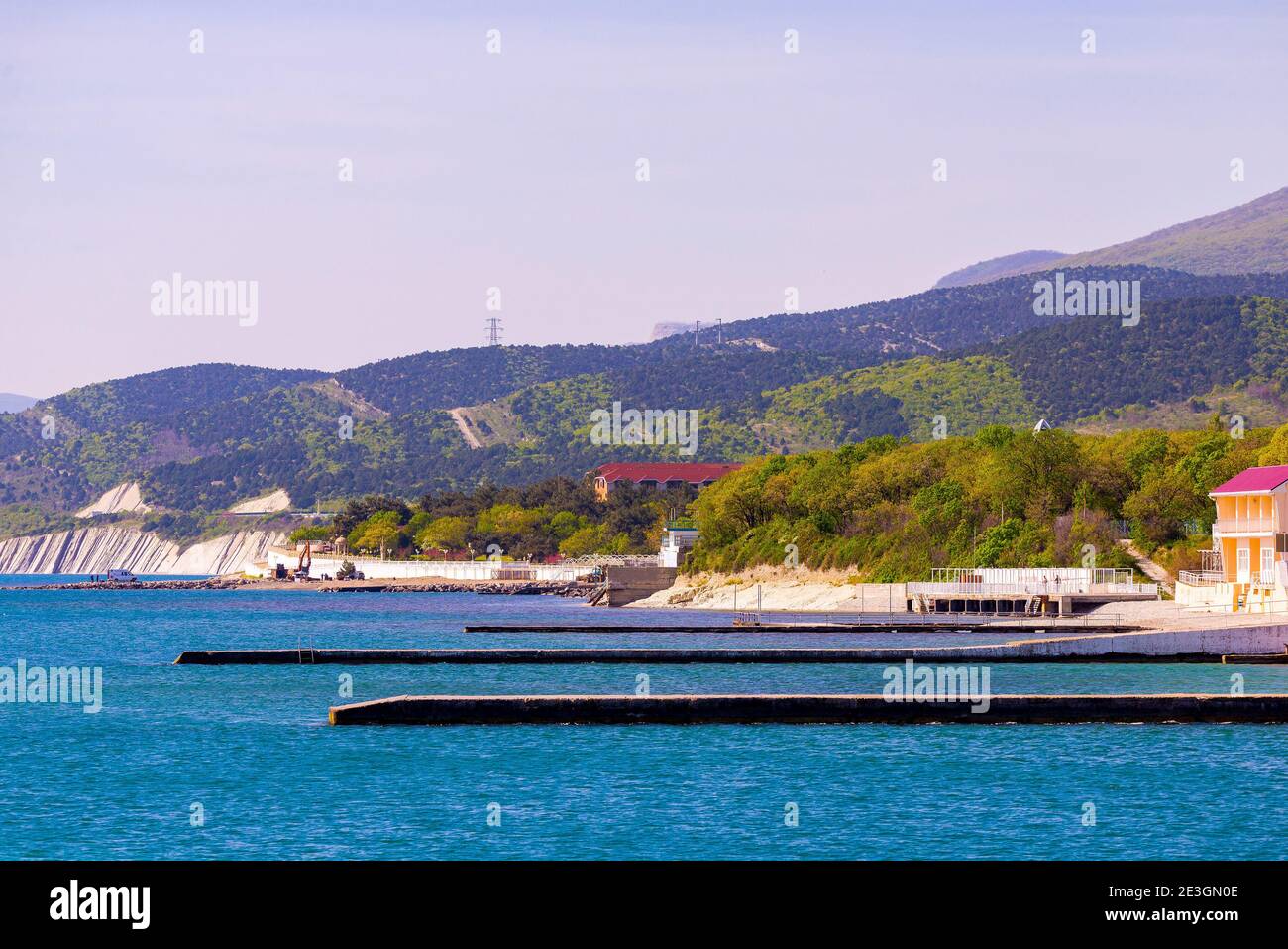Long concrete seawall or wave breaker for protect seashore Stock Photo