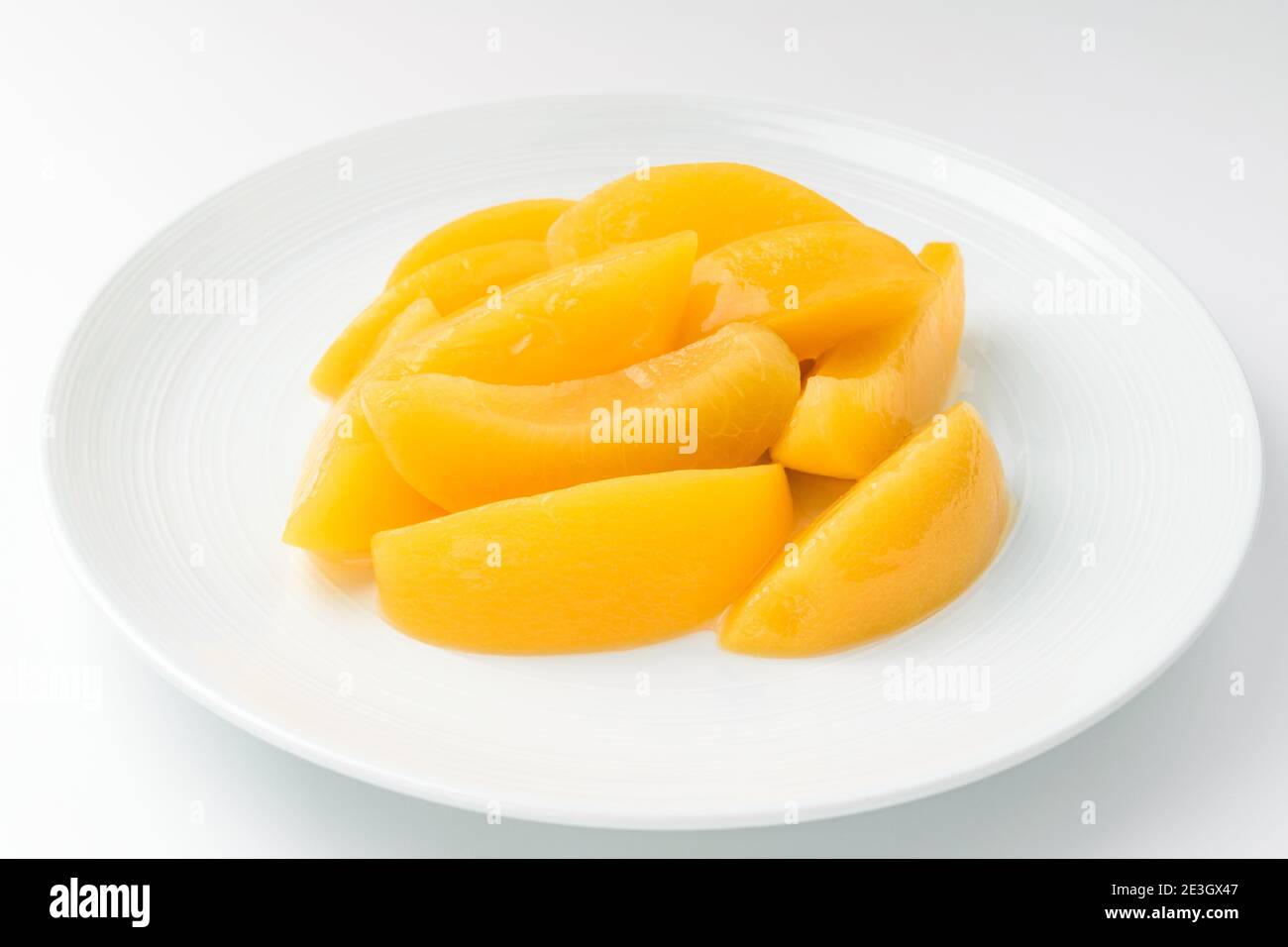 Canned peaches on a white background Stock Photo