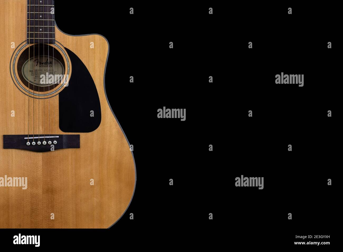 body part of classic yellow acoustic guitar Fender CD-60 with black  pickguard on isolated black background with space for text Stock Photo -  Alamy