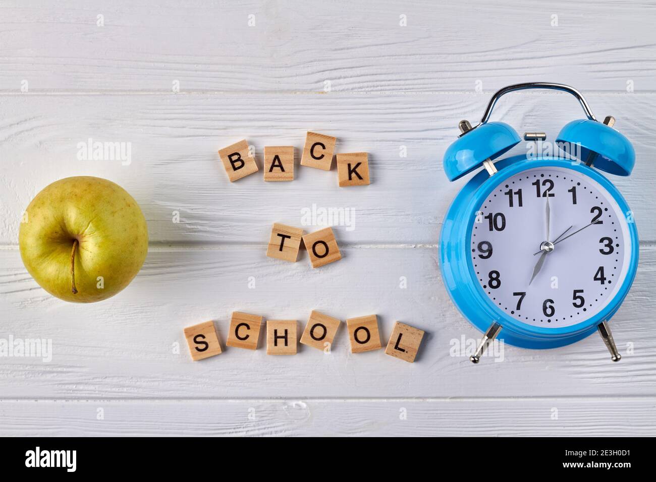 Alarm clock and green apple Stock Photo Alamy