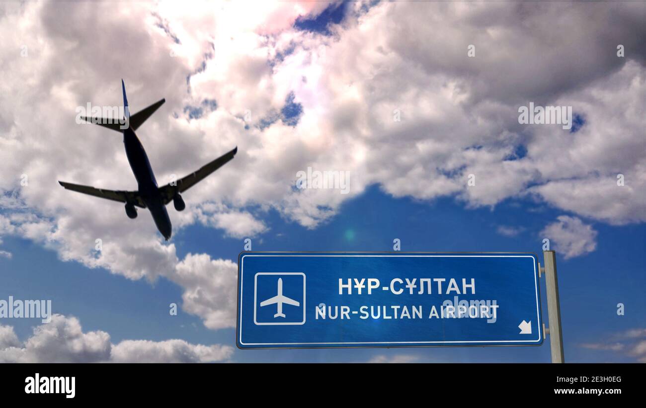 Airplane silhouette landing in Nur-Sultan, Astana, Kazakhstan. City arrival with international airport direction signboard and sky in background. Trav Stock Photo