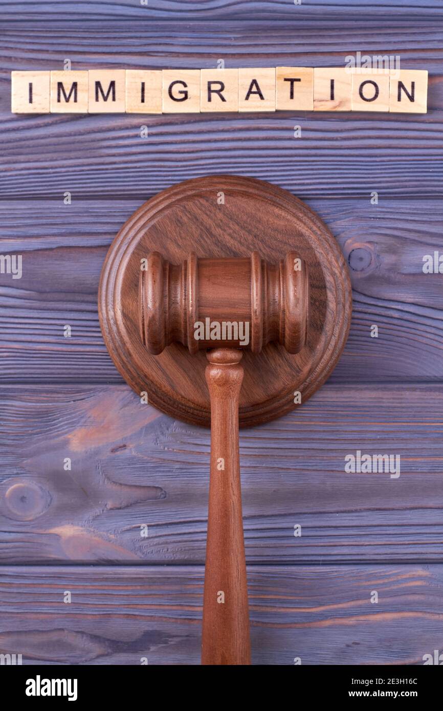 Immigration law wooden gavel. Stock Photo