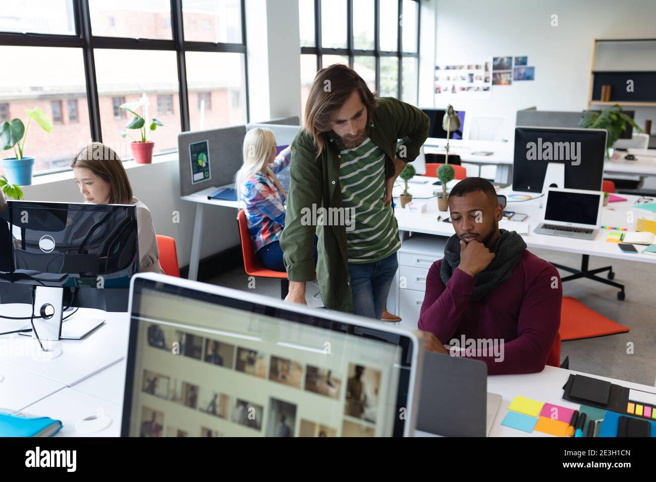 Two diverse businessmen working in creative office Stock Photo