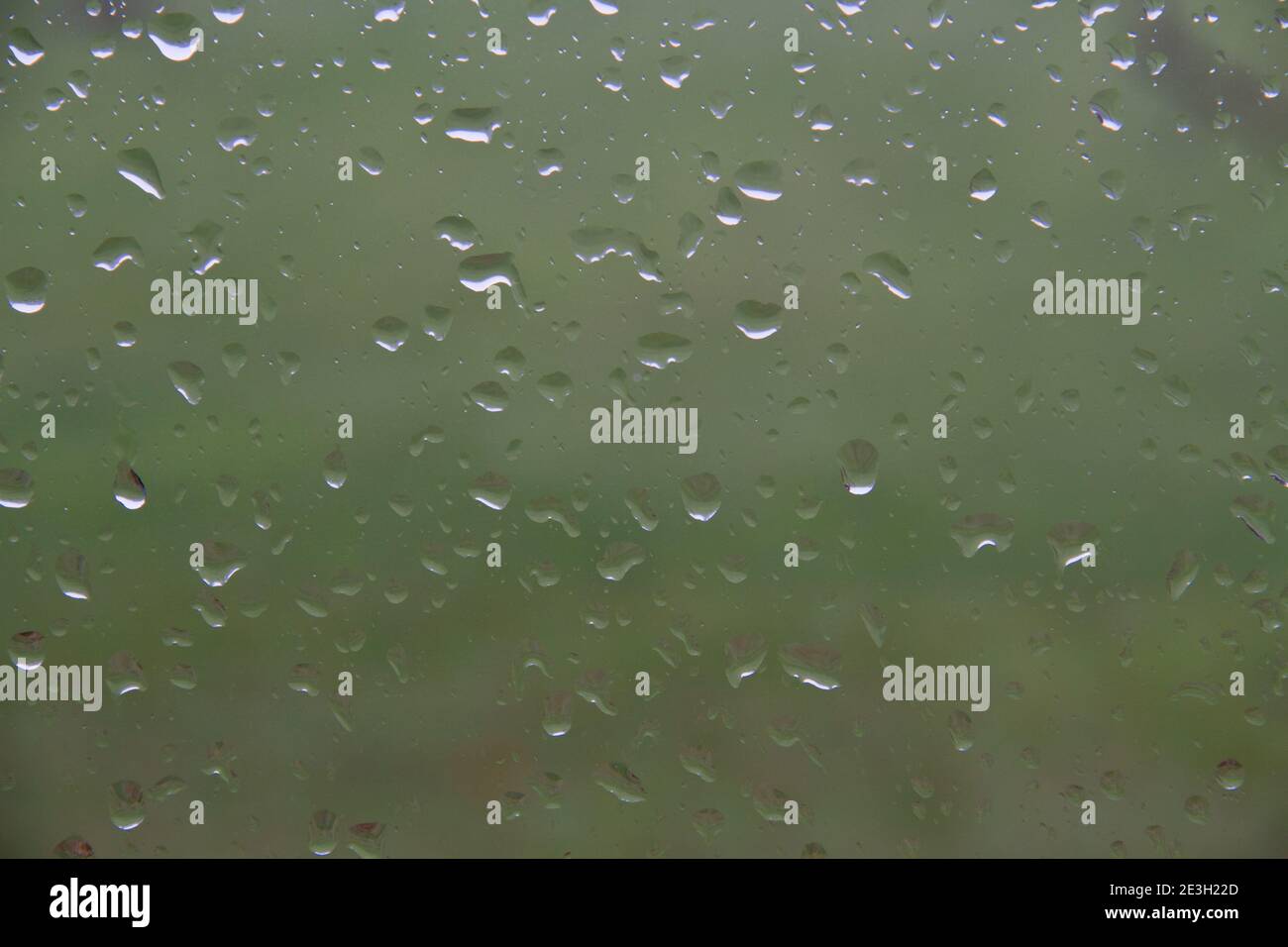 Drizzly day: raindrops on window, view from inside. Stock Photo