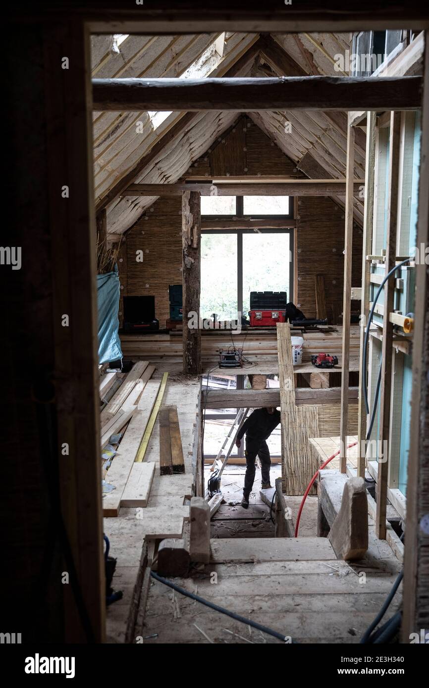 Renovation of a house using eco-friendly materials, bio-based materials such as reed used here for insulation Stock Photo