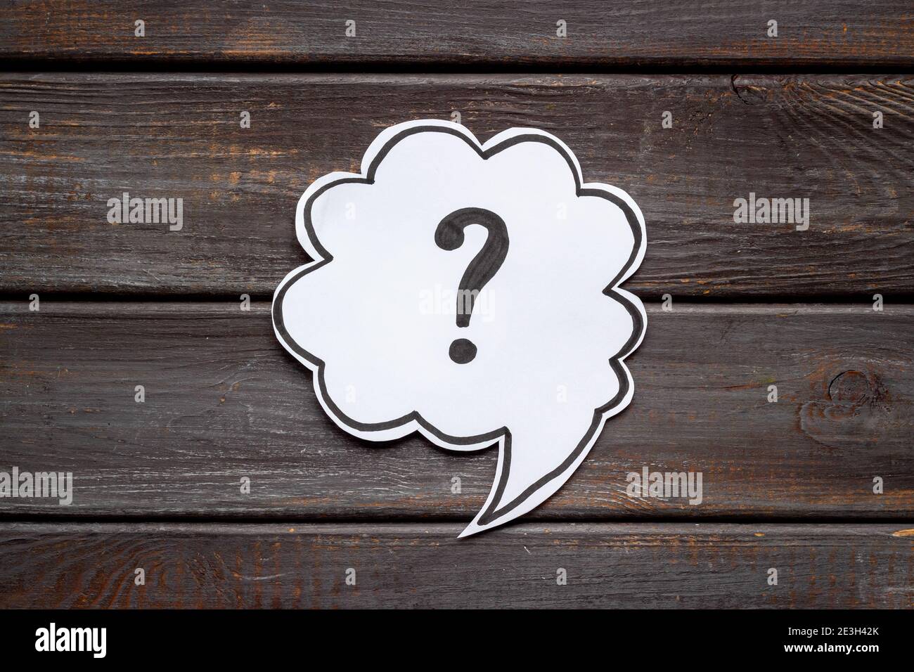 Question mark symbol on speech bubble, top view Stock Photo