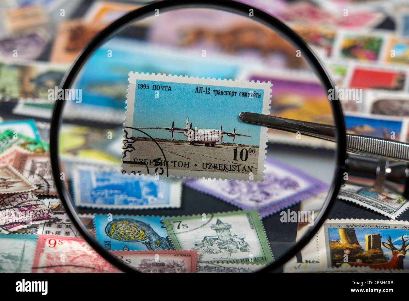 Stamp collection, collect, postage stamps, postage stamps from different countries, magnifying glass, stamp with aeroplane from Uzbekistan, Antonov An Stock Photo