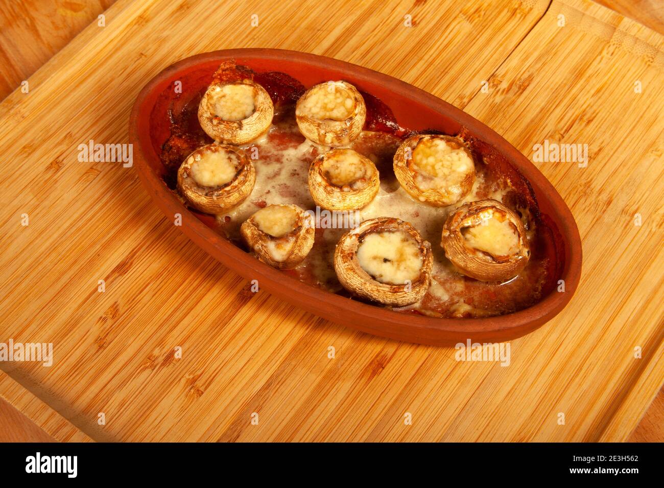 Baked white mushrooms in butter Stock Photo Alamy