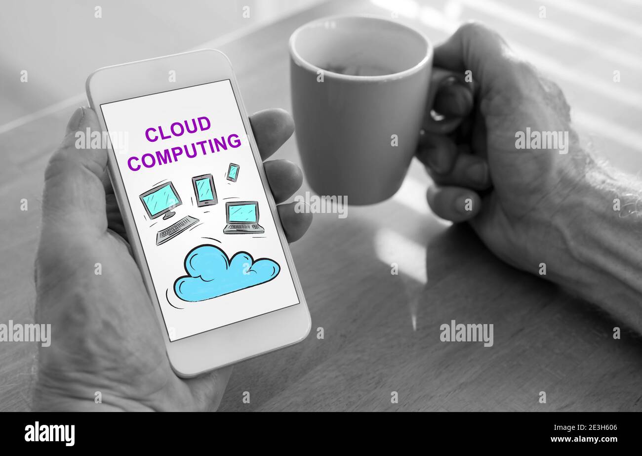 Male hands holding a smartphone with cloud computing concept and a cup ...