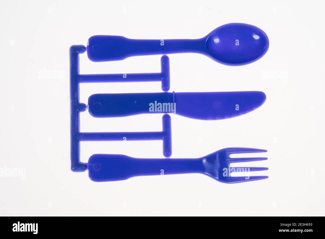 Plastic cutlery, spoon, knife, fork, still on the cast iron strand, children's cutlery, Stock Photo