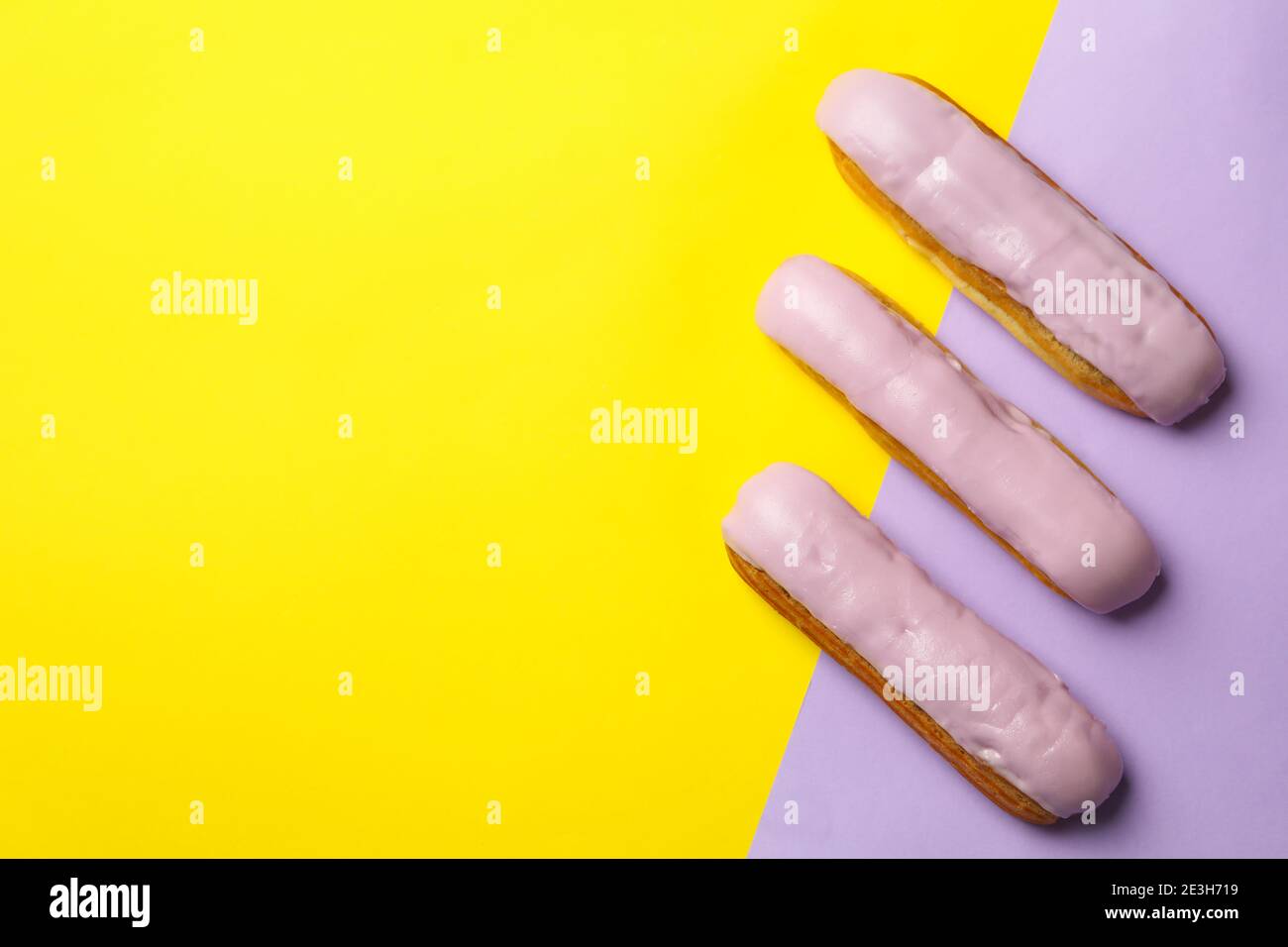 Delicious eclairs with custard on two tone background Stock Photo