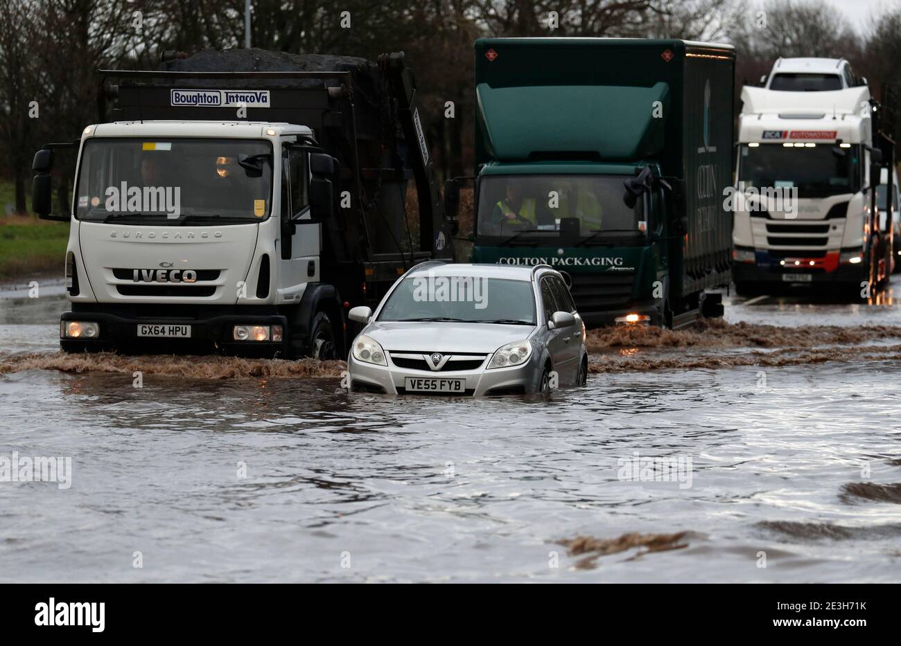 Hathern, Leicestershire, UK. 19th January 2021. UK weather. Lorries are driven past a car stranded in flood water. Storm Christoph is set to bring widespread flooding to parts of England. Credit Darren Staples/Alamy Live News. Stock Photo