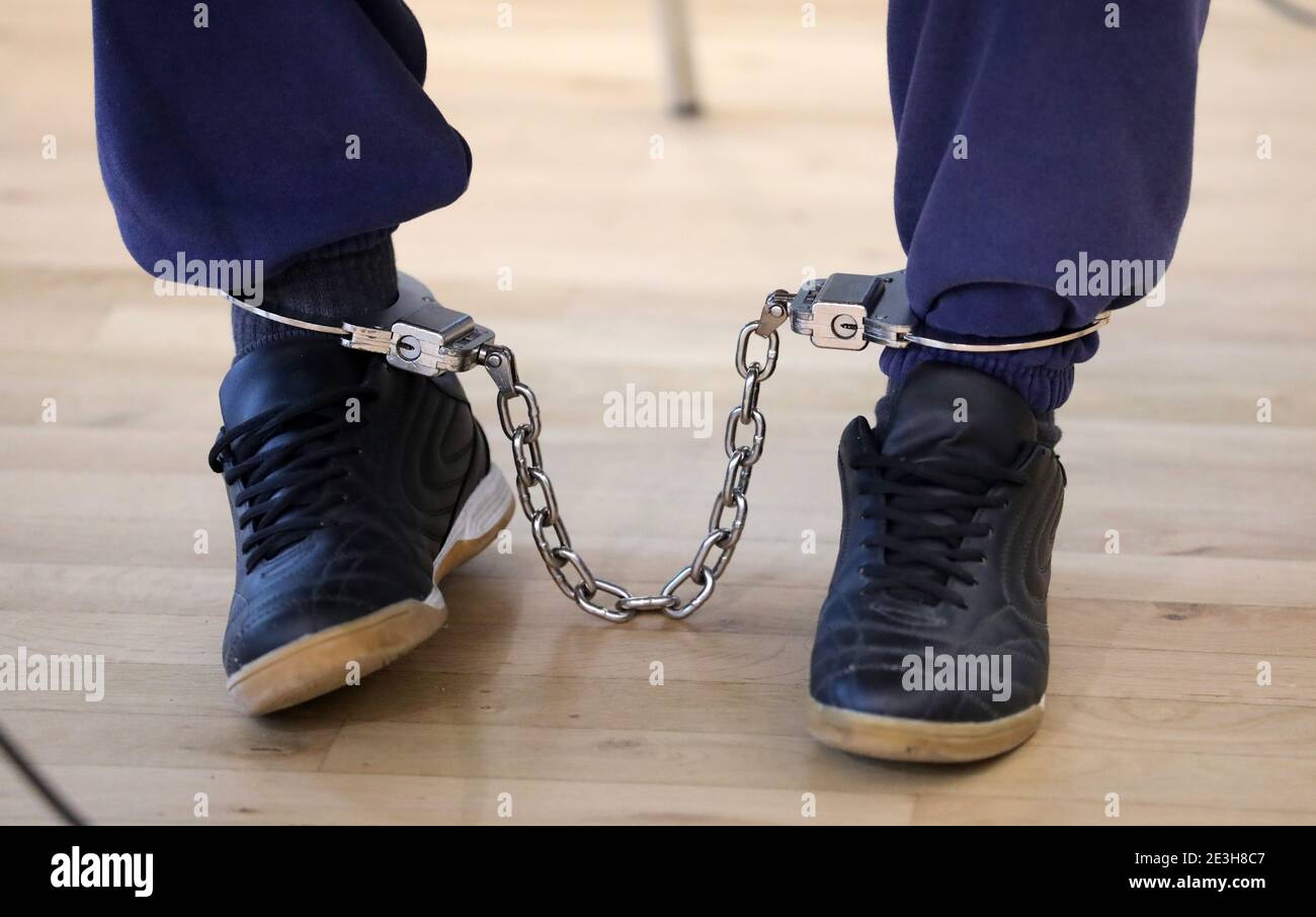 Neubrandenburg, Germany. 19th Jan, 2021. The accused stepfather in the trial of the violent death of six-year-old Leonie from Vorpommern is sitting in the courtroom of the regional court with an ankle bracelet before the start of the appeal proceedings. In the new trial, the motives of the 29-year-old are to be examined more closely. This had been ordered by the Federal High Court (BGH). The stepfather was sentenced to life imprisonment a year ago for murder by omission, bodily harm resulting in death, and mistreatment of protected children. Credit: Bernd Wüstneck/dpa-Zen/dpa/Alamy Live News Stock Photo