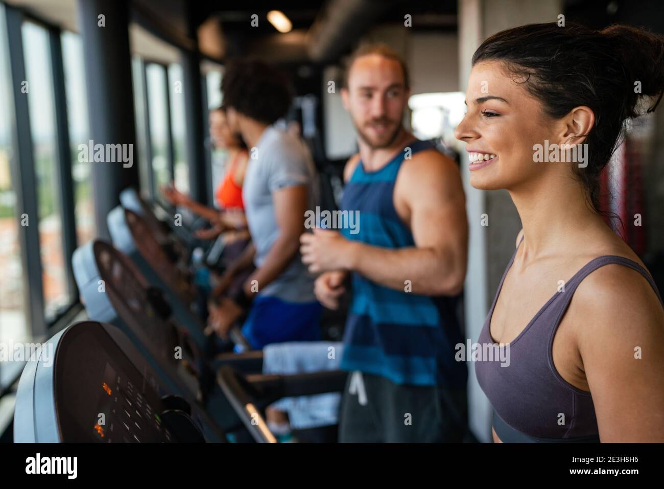 Group of young people running on treadmills in sport gym Stock Photo ...