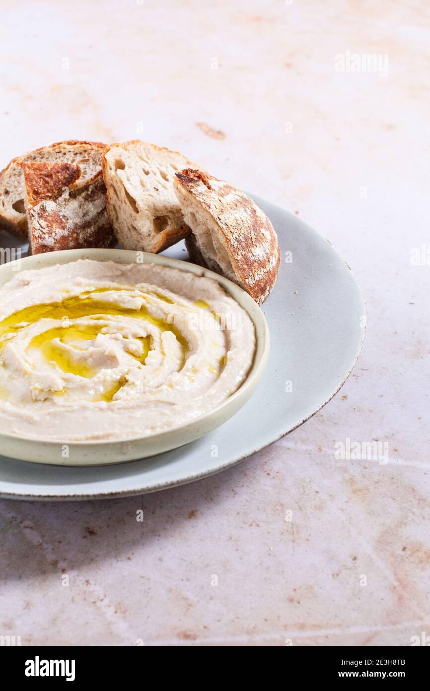 Cannellini bean dip topped with olive oil and served with crusty bread