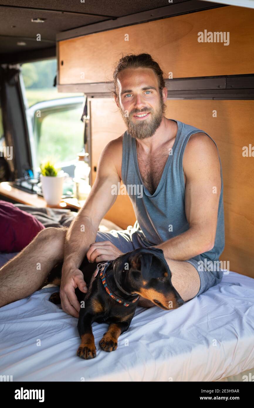 Man and his dog in a camper van Stock Photo