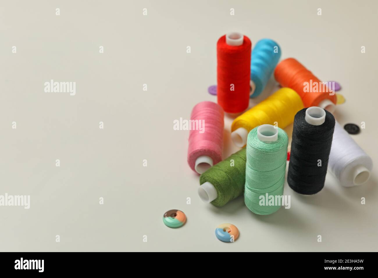 Sewing threads and buttons on white background, space for text Stock ...