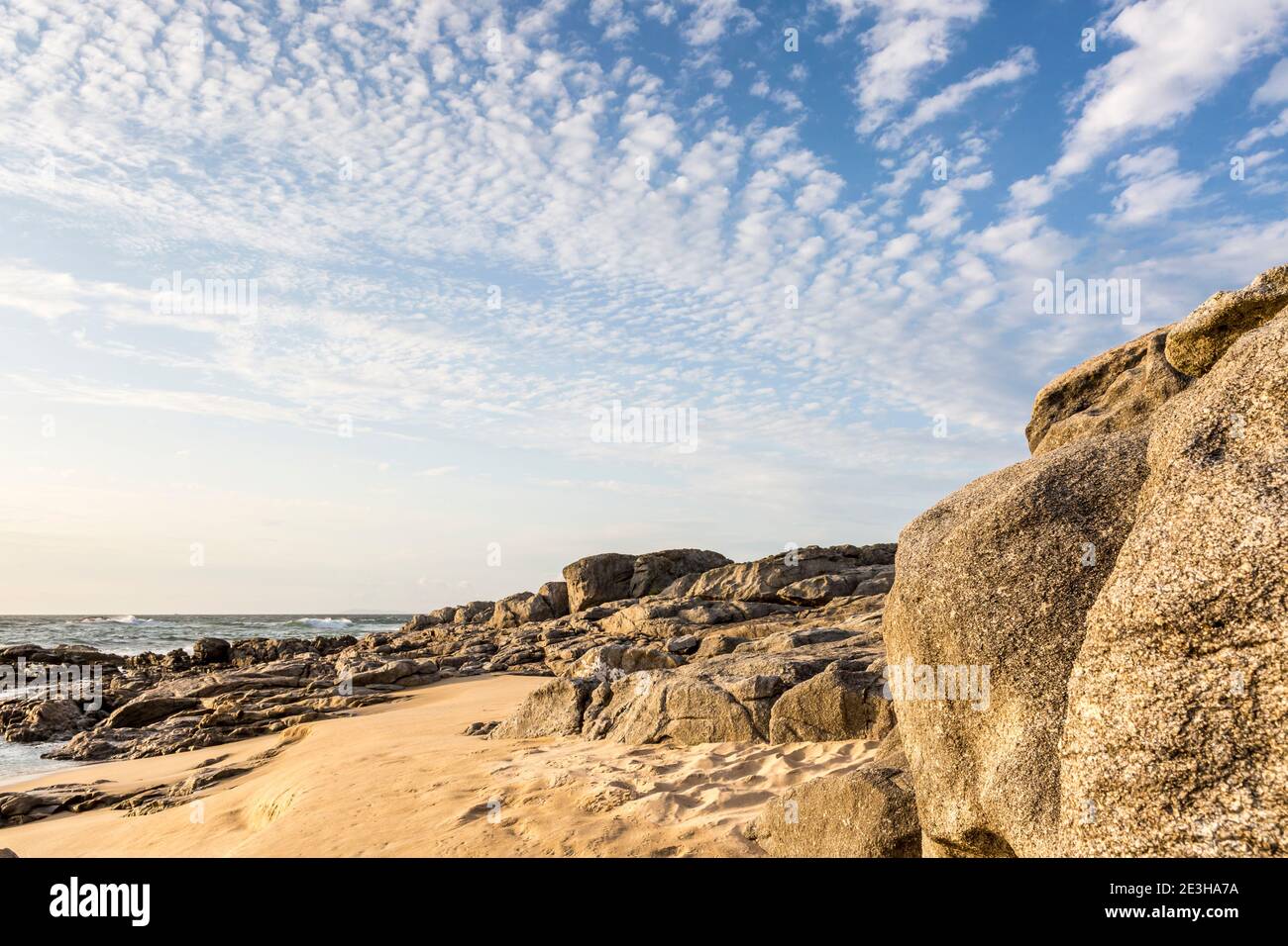 Rock formation on a beautiful sandy beach at sunset, Playa de Seráns, A Coruña, Atlantic Ocean, Galicia, Spain Stock Photo
