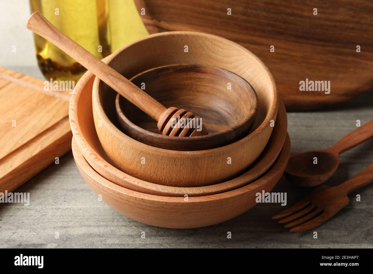 Different wooden kitchenware on gray table, close up Stock Photo - Alamy