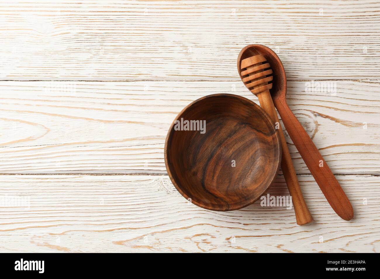 Bowl, dipper and spoon on white wooden background Stock Photo - Alamy