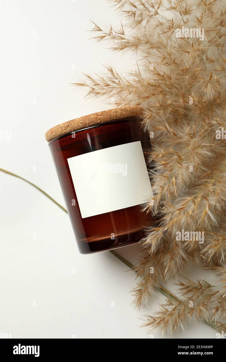 Scented candle and reed on white background Stock Photo