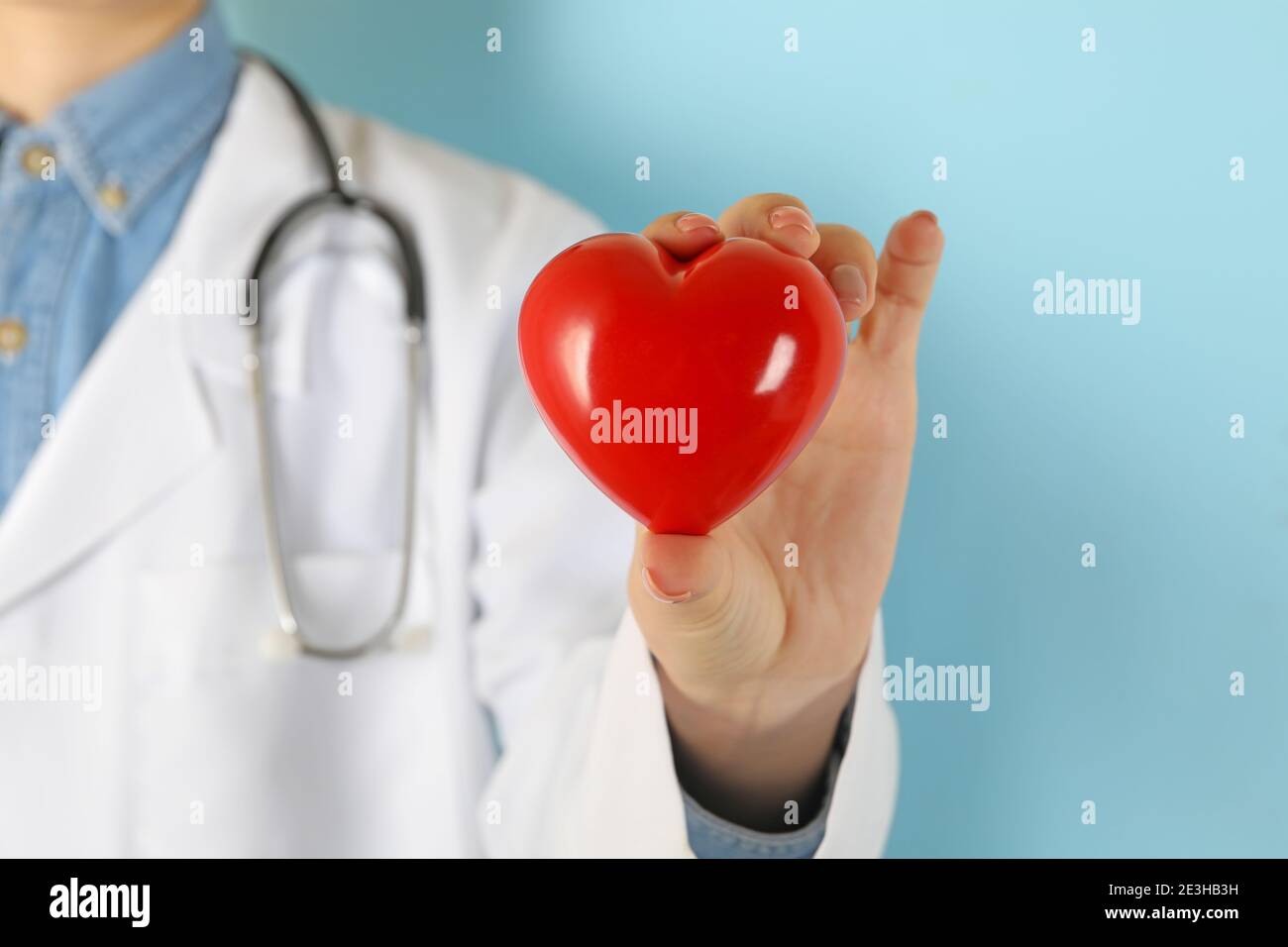 Female doctor with stethoscope holding red heart Stock Photo - Alamy