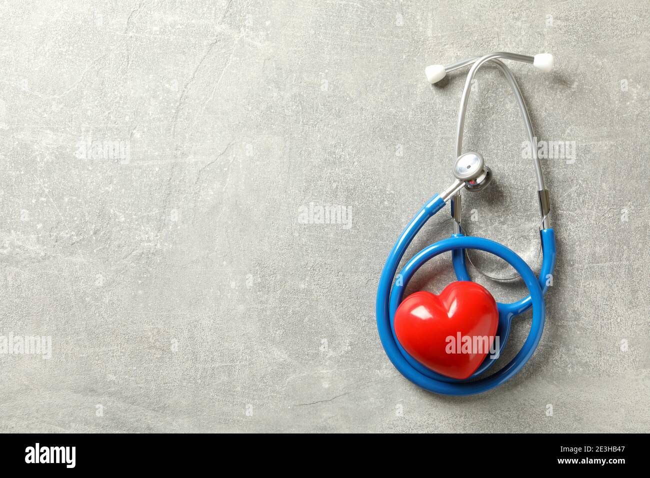 Blue stethoscope and heart on gray background Stock Photo - Alamy