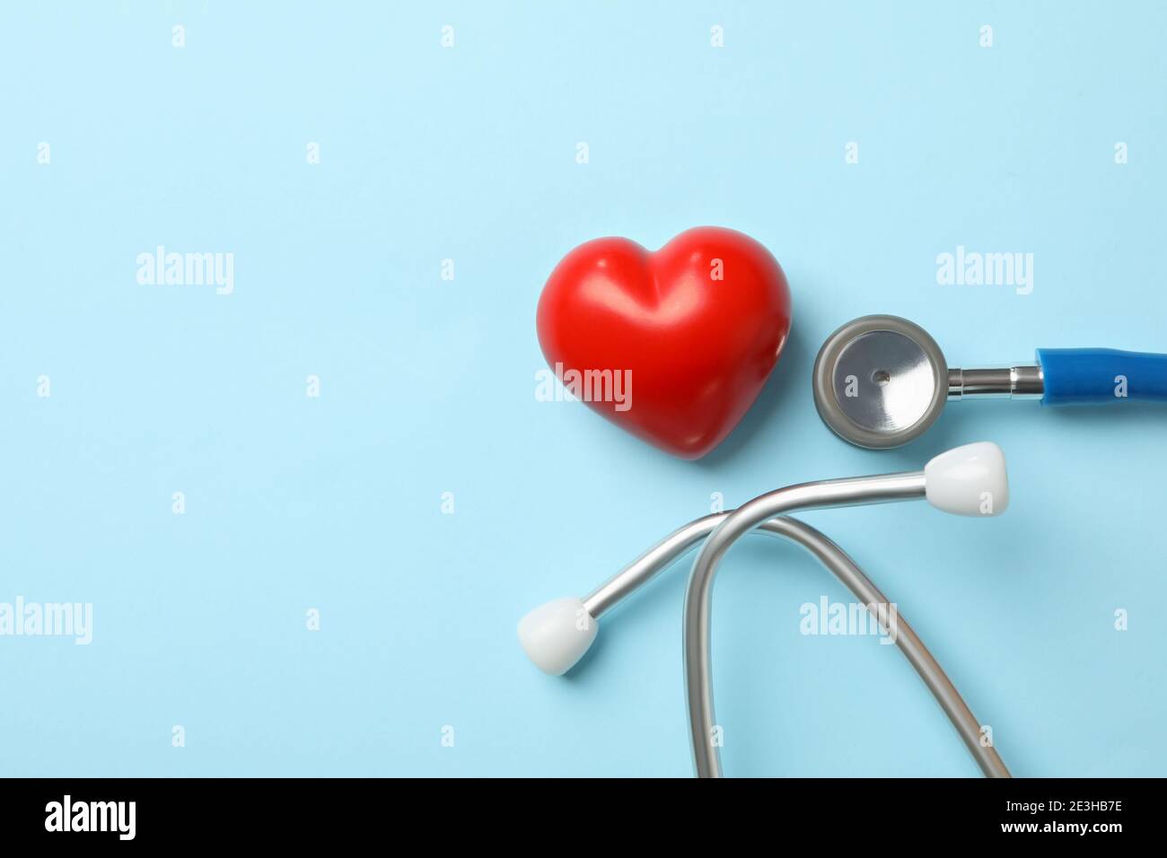 Blue stethoscope and heart on blue background Stock Photo - Alamy
