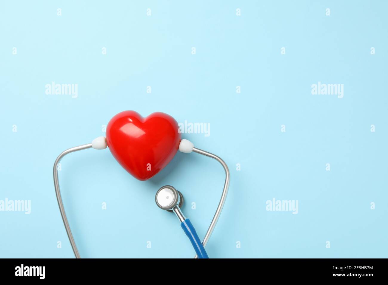 Blue stethoscope and heart on blue background Stock Photo - Alamy