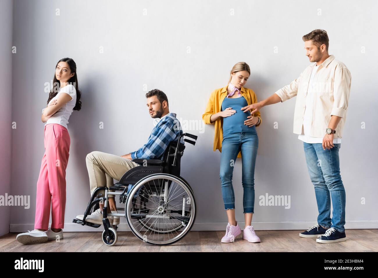 Multicultural people, pregnant woman and disabled man in wheelchair