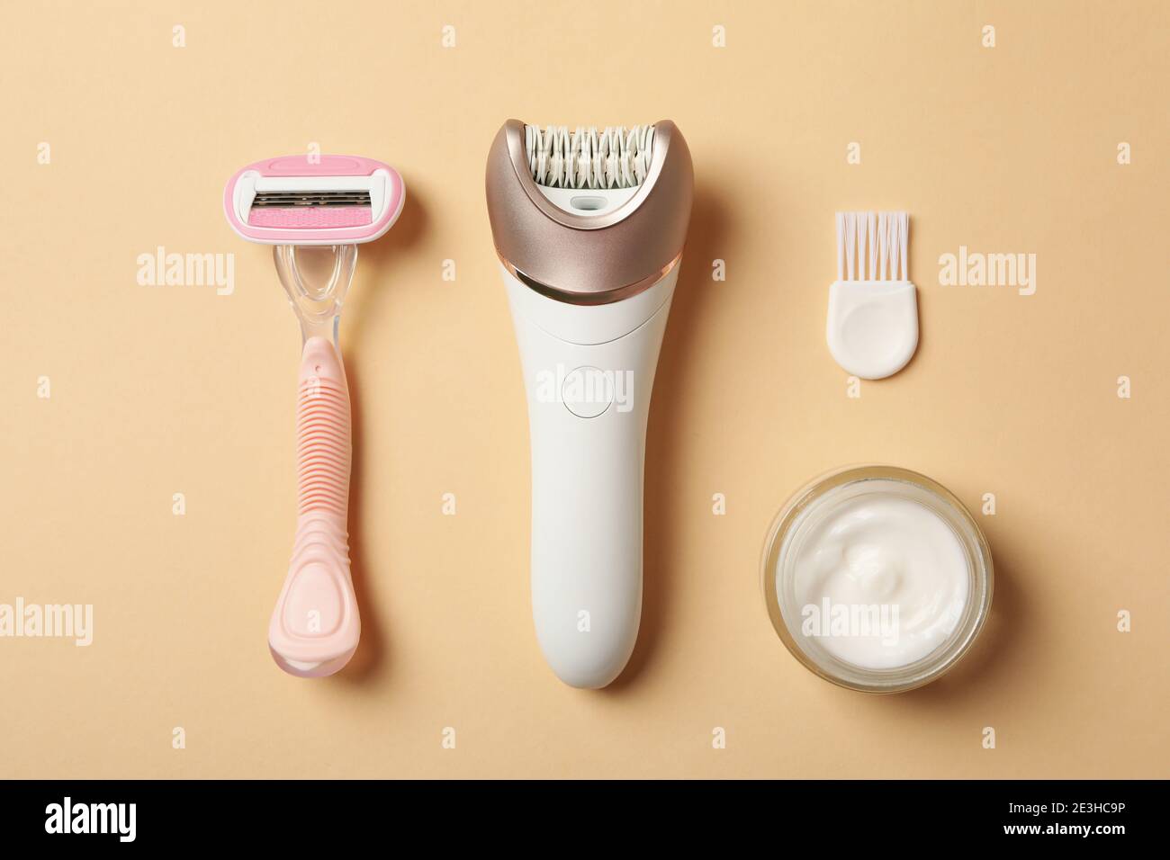 Epilator, razor and cream on beige background Stock Photo Alamy