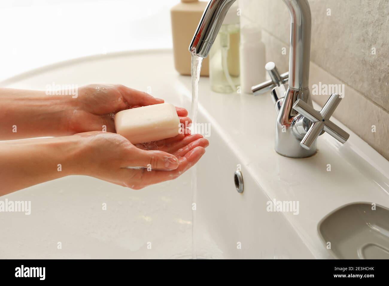 Woman washing hands in bathroom sink with soap Stock Photo - Alamy