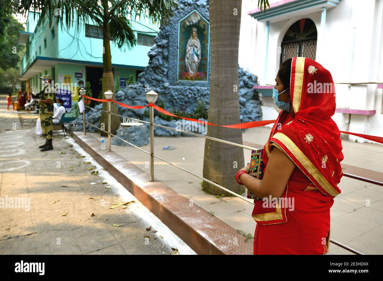 A woman voter waiting for her turn to cast her vote at a polling booth during the state elections in Bihar. Stock Photo