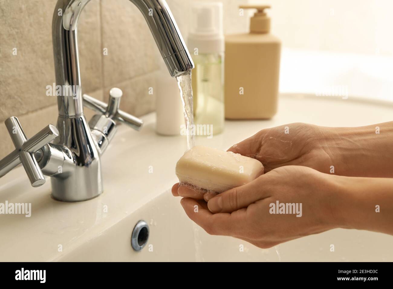Woman washing hands in bathroom sink with soap Stock Photo - Alamy