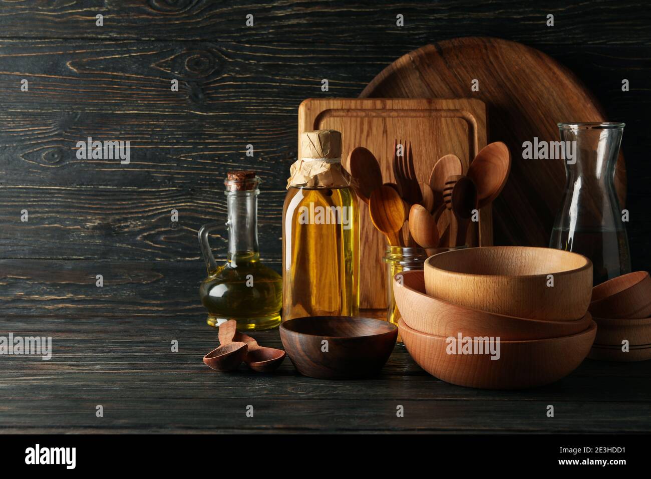 Different wooden kitchenware on wooden table, space for text Stock Photo