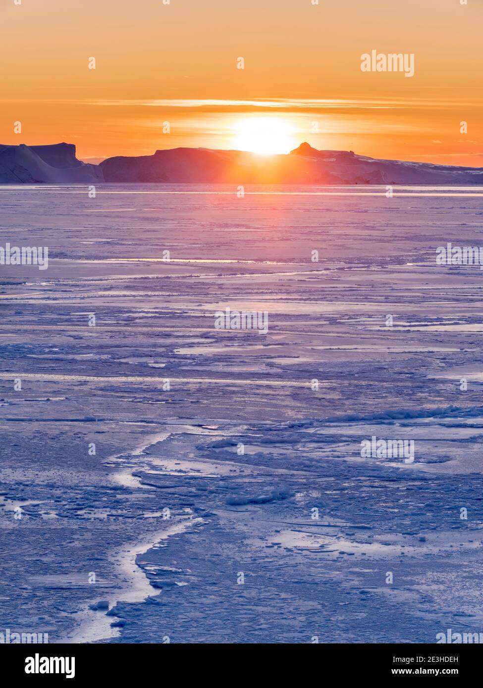 Sunset During Winter At The Ilulissat Icefjord Located In The Disko sunset-during-winter-at-the-ilulissat-icefjord-located-in-the-disko