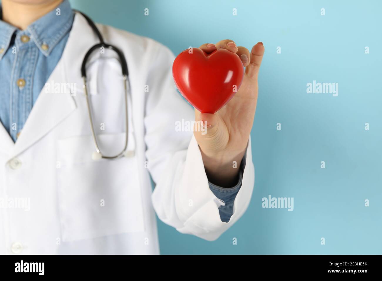 Female doctor with stethoscope holding red heart Stock Photo - Alamy