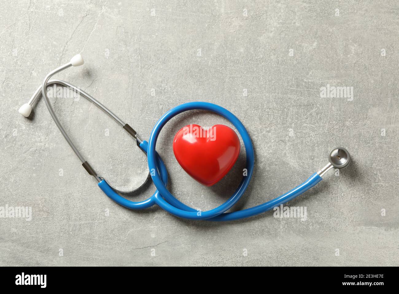 Blue stethoscope and heart on gray background Stock Photo - Alamy