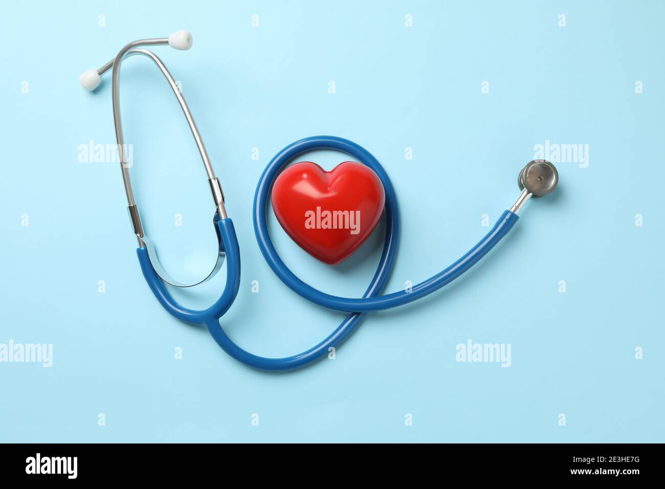 Blue stethoscope and heart on blue background Stock Photo - Alamy