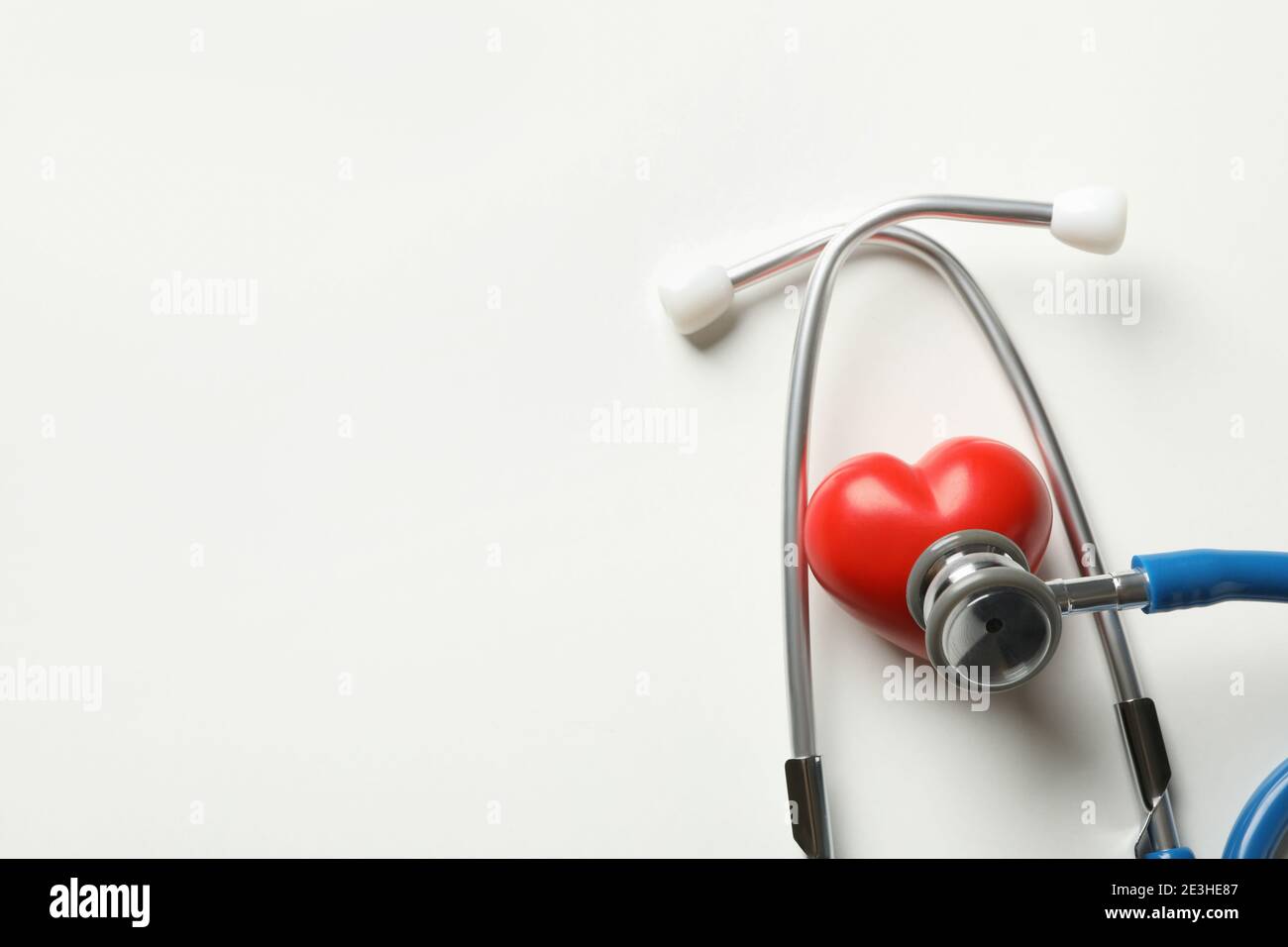 Blue stethoscope and heart on white background Stock Photo - Alamy