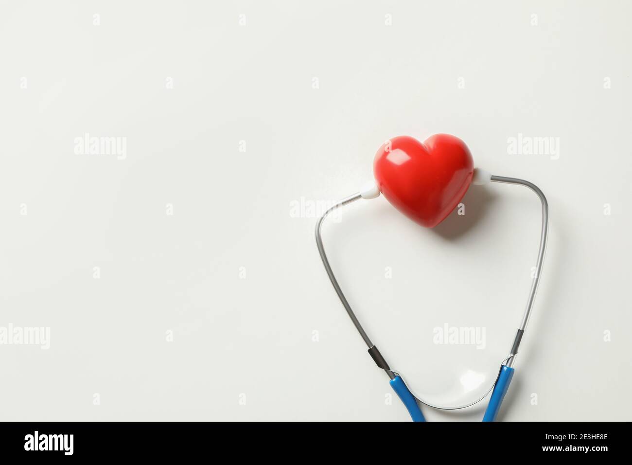 Blue stethoscope and heart on white background Stock Photo - Alamy
