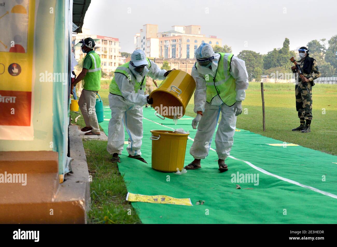 Frontline workers clearing biomedical waste at a polling booth during the state elections in Bihar. Stock Photo