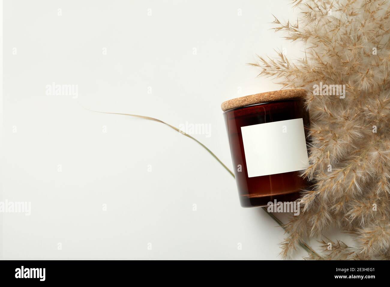 Scented candle and reed on white background Stock Photo
